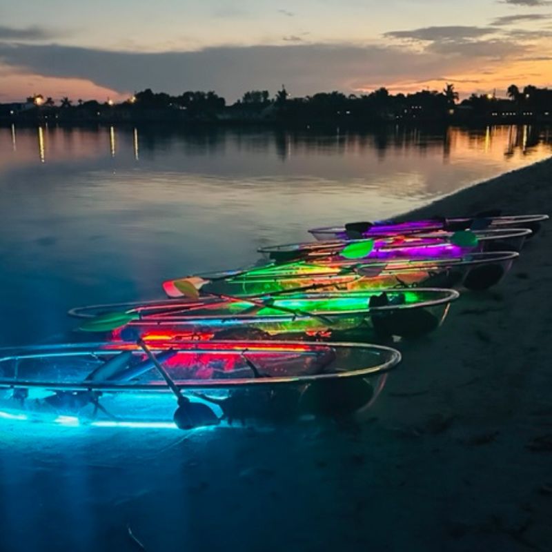see through kayaks with neon lights on the beach at kool kayak ami 3